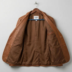 Interior of men's tan leather blazer with brown lining and inside pocket.