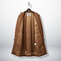 Interior of men's tan leather duffle coat showing smooth lining and inside pockets.