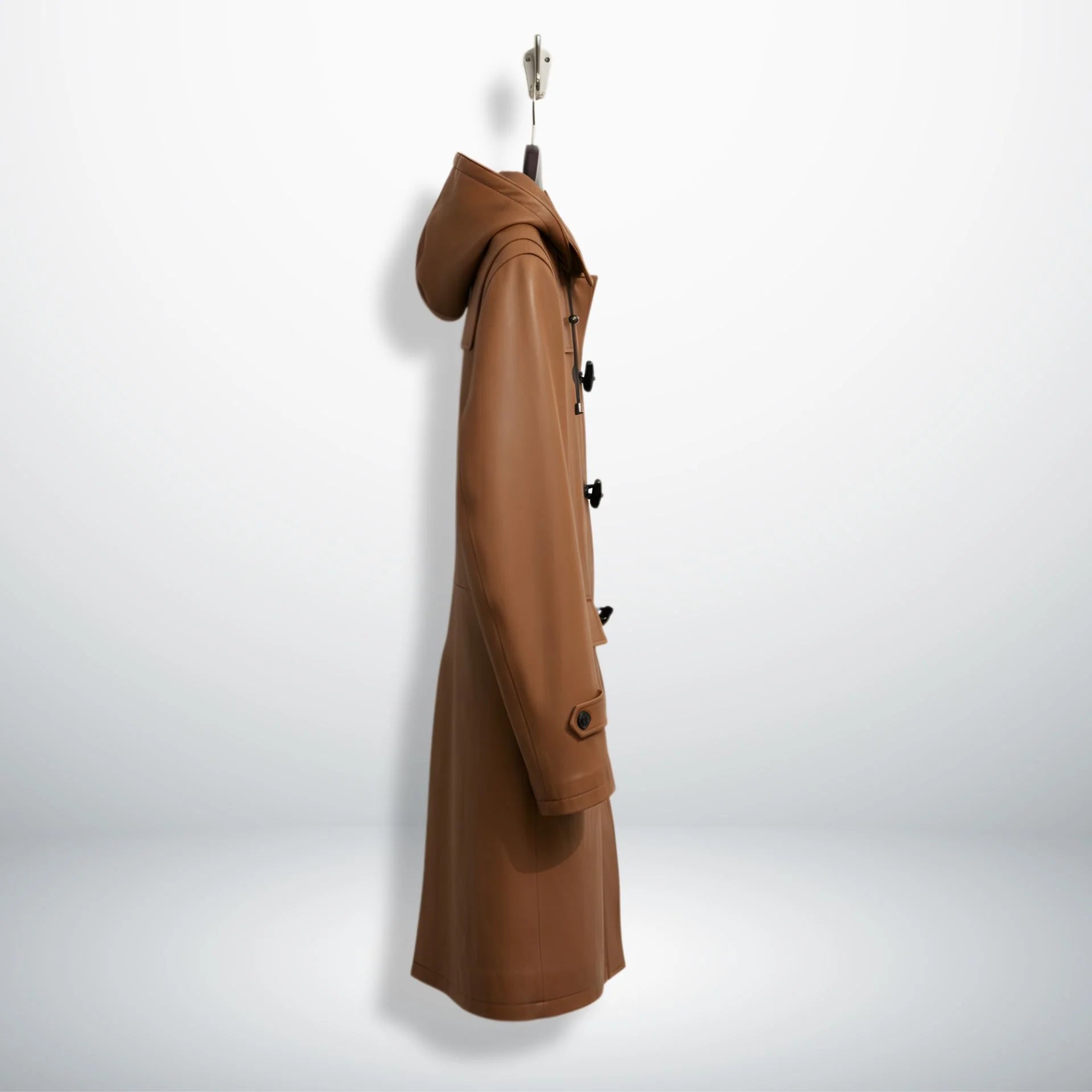 Side profile of men's tan leather duffle coat with hood and long length.