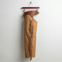 Opposite side view of men's tan fringe riding chaps with concho detail