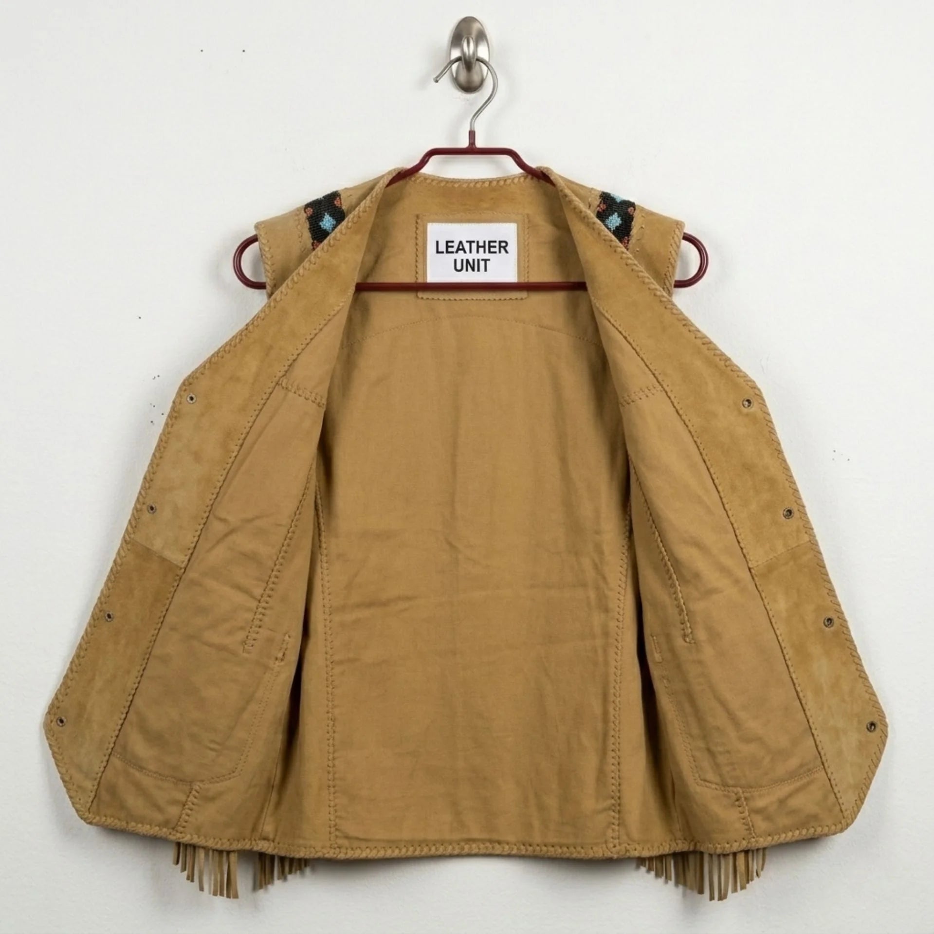 Interior view of men's tan suede cowboy vest showing lining and construction.