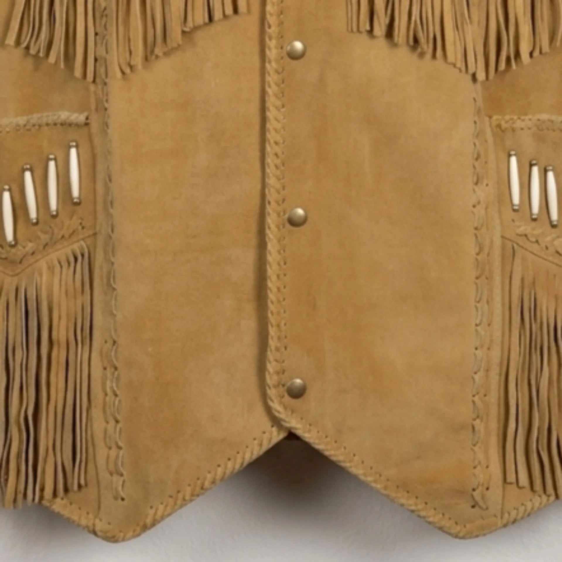Close up of snap front and pocket fringe on men's tan suede fringe vest.