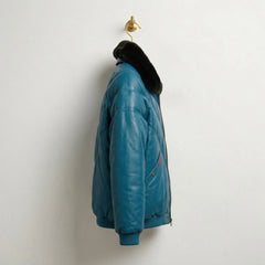 Side profile of teal leather bomber jacket showing V-panels and ribbed hem