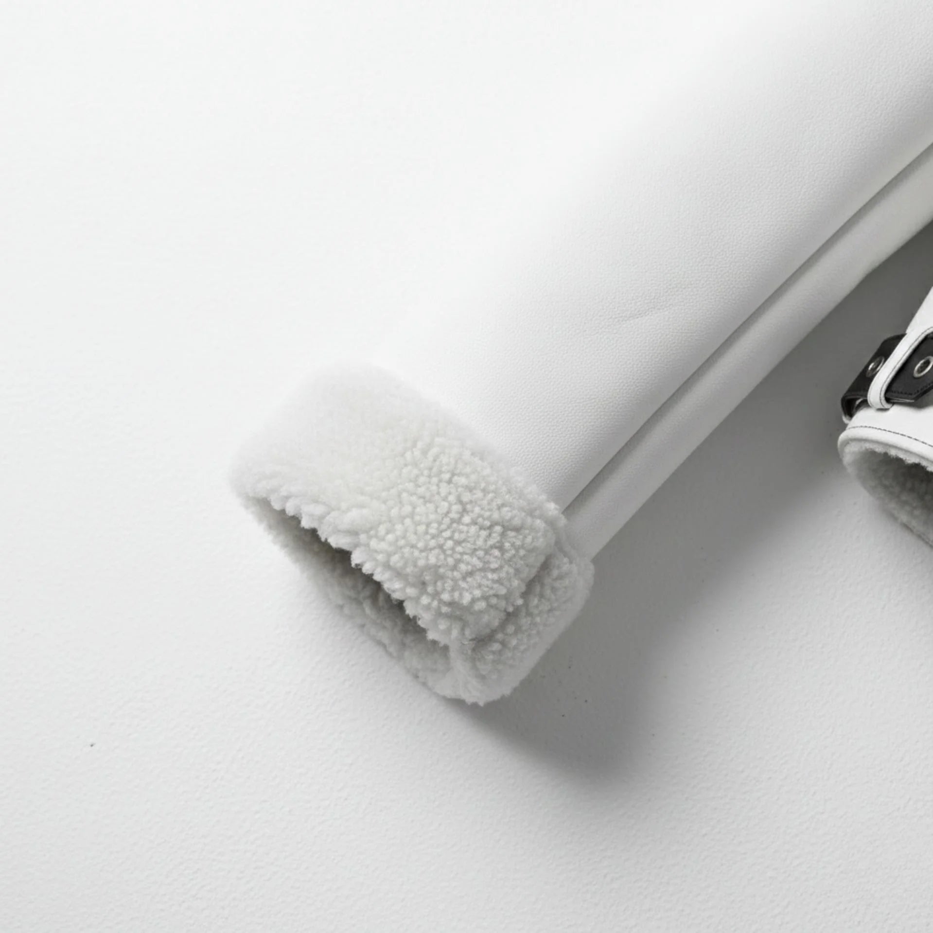 close up shearling cuff on mens white aviator bomber leather sleeve.