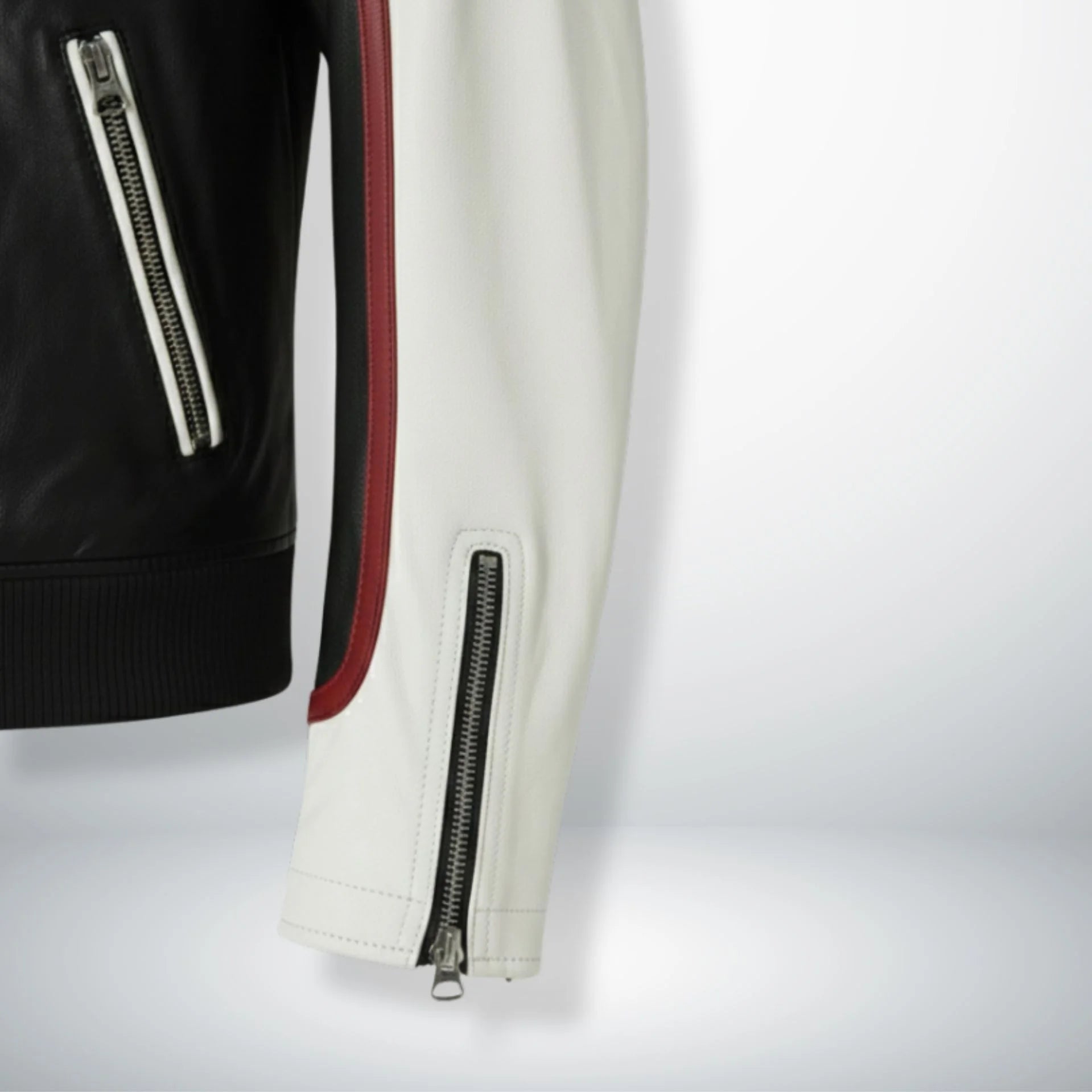 sleeve and cuff zipper close up on men's white and black leather biker jacket.