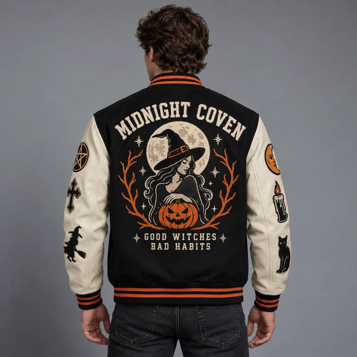 Back model view of witch Halloween varsity jacket featuring full moon, pumpkin and Midnight Coven embroidered artwork