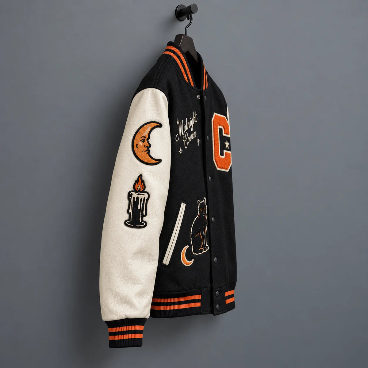 Side angle of Midnight Coven jacket showing cream leather sleeve with crescent moon and candle embroidered patches