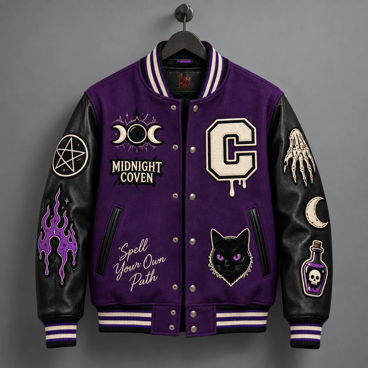 Front hanger view of purple witchcraft varsity jacket with Midnight Coven, triple moon and black cat patches