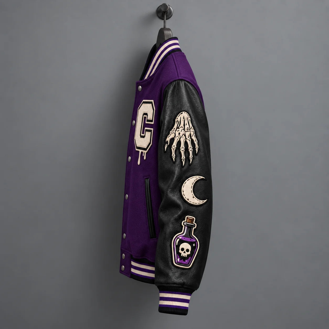 Side profile of Halloween varsity jacket showing skeletal hand, crescent moon and potion bottle sleeve patches
