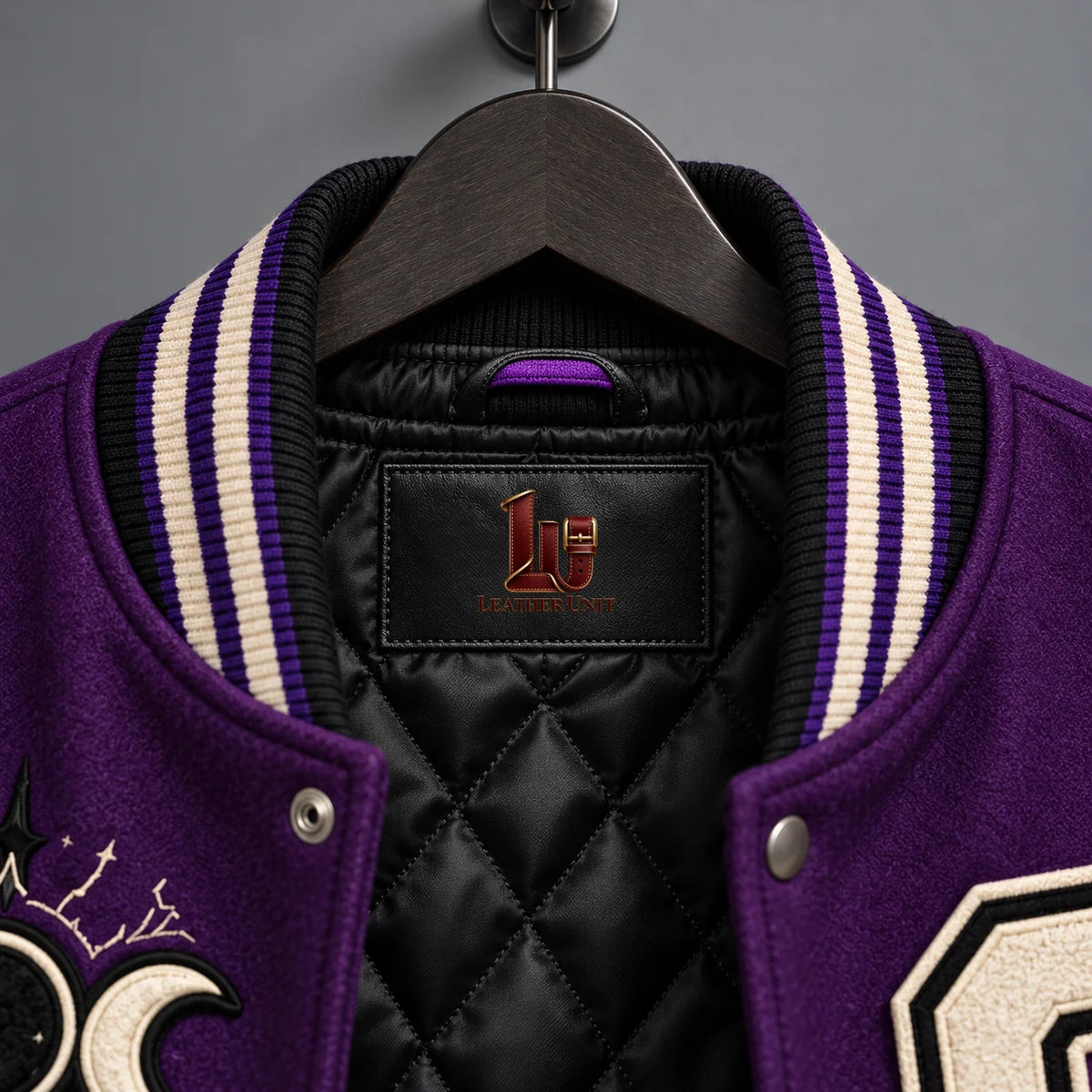 Close-up of Leather Unit neck label, black diamond-quilted lining and purple cream striped varsity collar