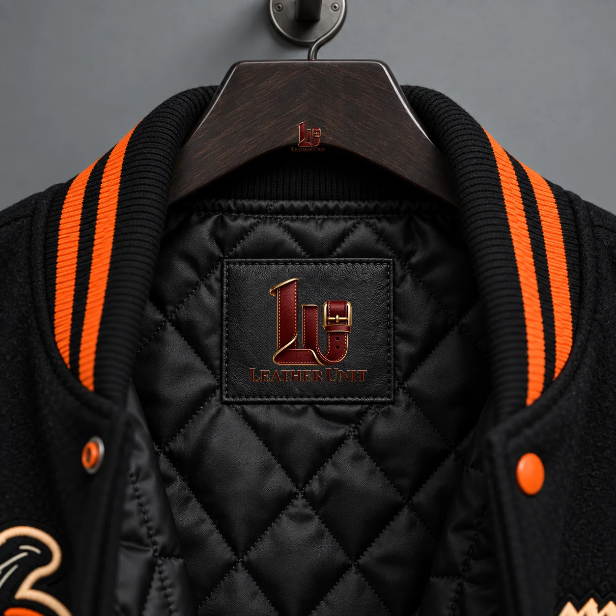 Close-up of black quilted jacket lining, orange striped rib collar and Midnight Ritual interior branding patch