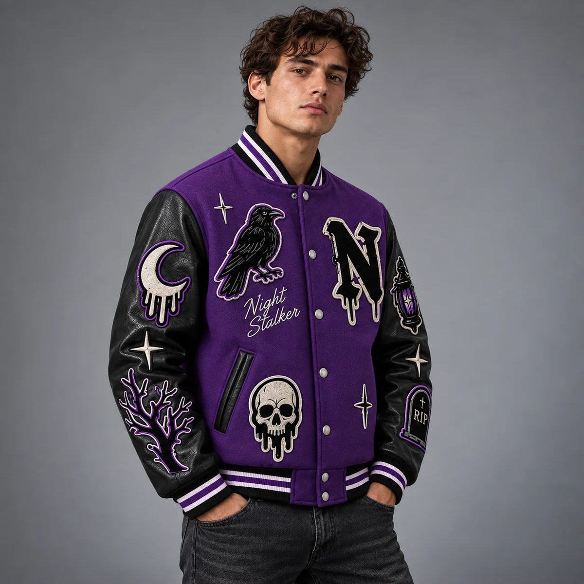 Three-quarter model view of purple gothic varsity jacket showing raven, skull, moon and gravestone embroidery