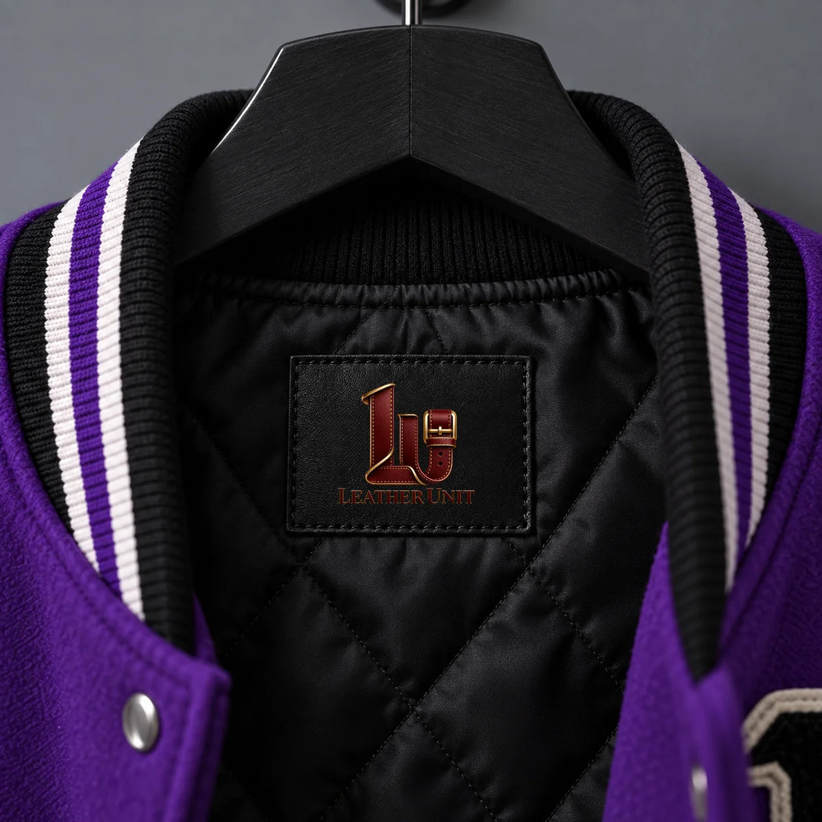 Close-up of Night Stalker black quilted lining and black white purple striped varsity collar