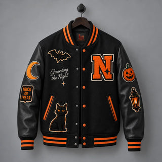 Front product view of Night Watch black varsity jacket on wooden hanger with Halloween patches and orange snap buttons