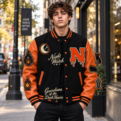 Lifestyle front view of Night Watch black and orange Halloween varsity jacket with Grim Reaper and embroidered patches