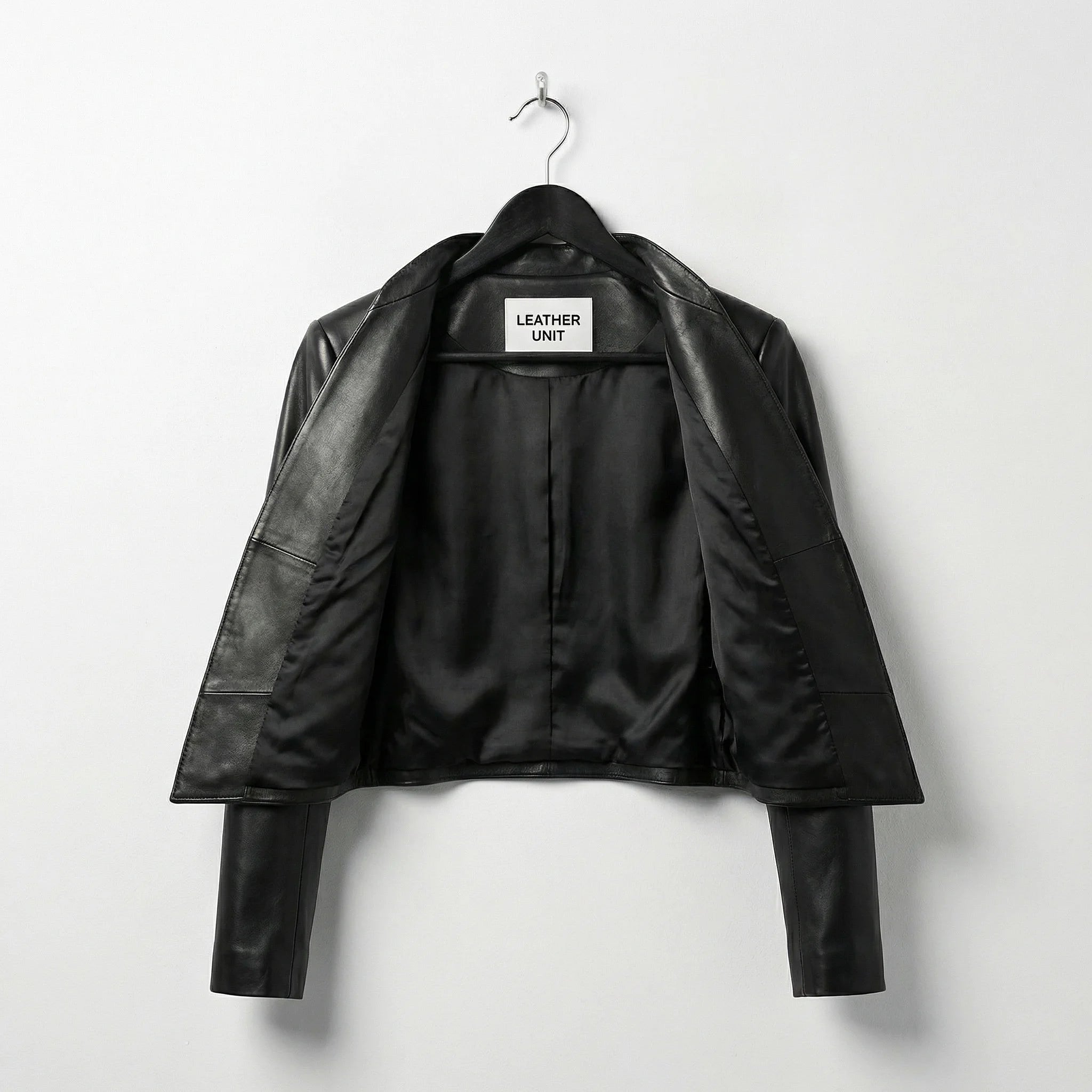 Interior lining of womens black leather jacket with open front

