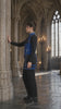 A model wears a cobalt blue underbust corset and matching thigh harness over black clothing. The video moves between full-body poses, close-ups of the front buckles and collar, and a side view in a Gothic interior, ending with a white studio view.