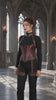 Product video featuring a plum leather corset harness set, with a contoured underbust silhouette, fan-shaped front detailing and coordinating shoulder and thigh straps.