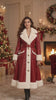 A model presents a red leather Christmas coat with wide ivory-white faux fur lapels, matching cuffs, gold-tone button details and a belted waist. The video shows standing poses, movement, a close-up and seated styling in a decorated holiday interior.