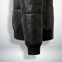 Close-up of ribbed cuffs and waistband on black puffer leather jacket
