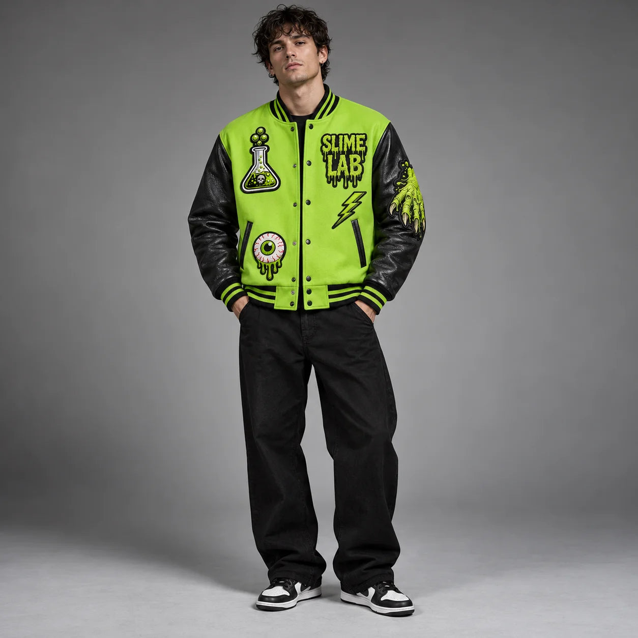 Front studio view of neon green Mad Scientist varsity jacket with flask, eyeball, lightning and slime hand patches