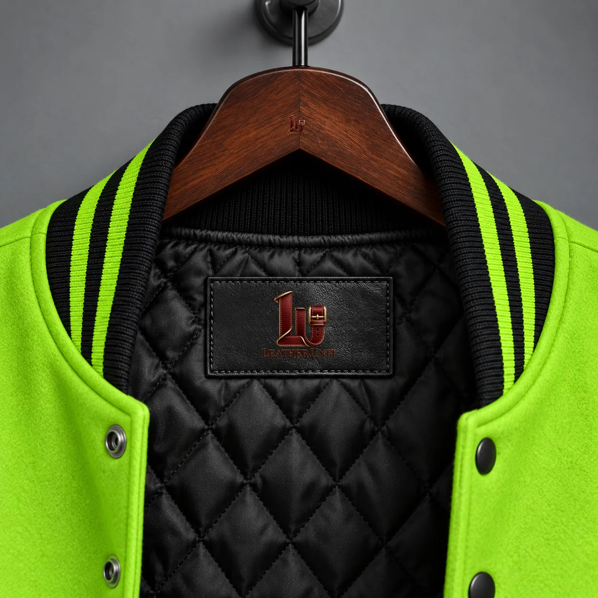Close-up of black quilted lining, black and acid-green rib collar and Leather Unit label inside Slime Lab jacket