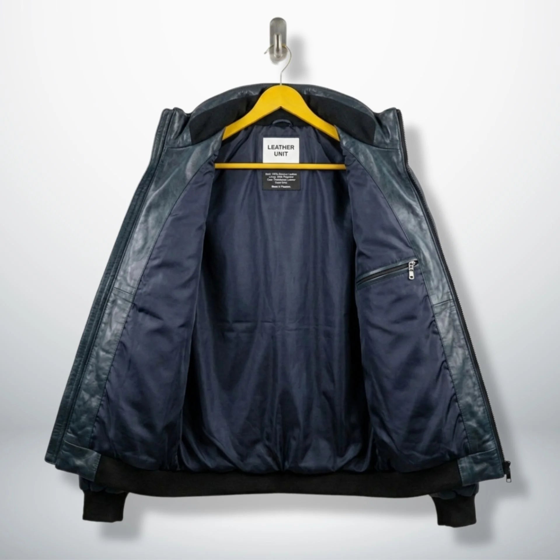 Interior view of Teal Leather Puffer Bomber Jacket with Leather Unit branding