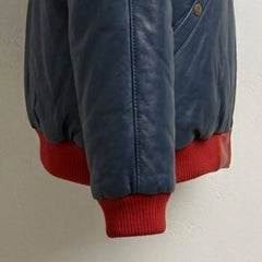 Detailed view of red ribbed cuff and premium leather texture
