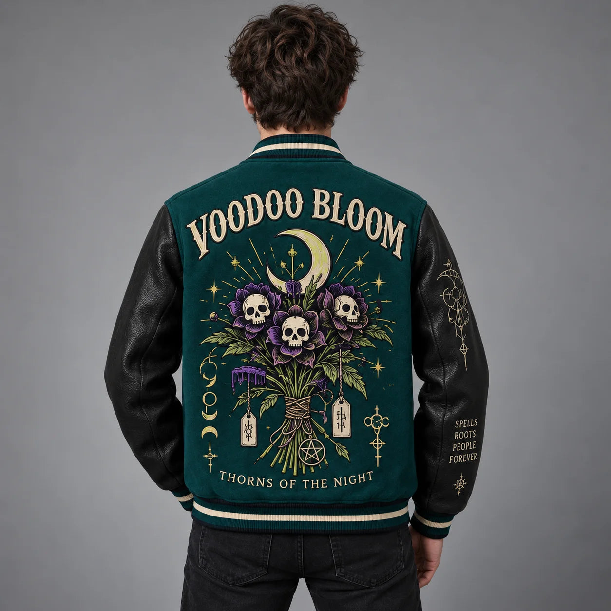 Back studio view of Voodoo Bloom varsity jacket with skull flowers, crescent moon and embroidered gothic artwork
