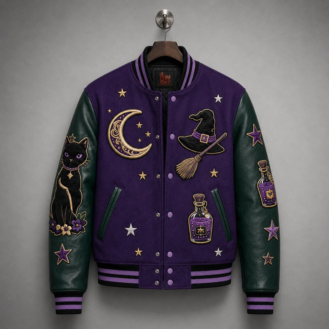 Hanging front view of purple varsity jacket with dark emerald cowhide sleeves, striped ribbing and Halloween embroidery