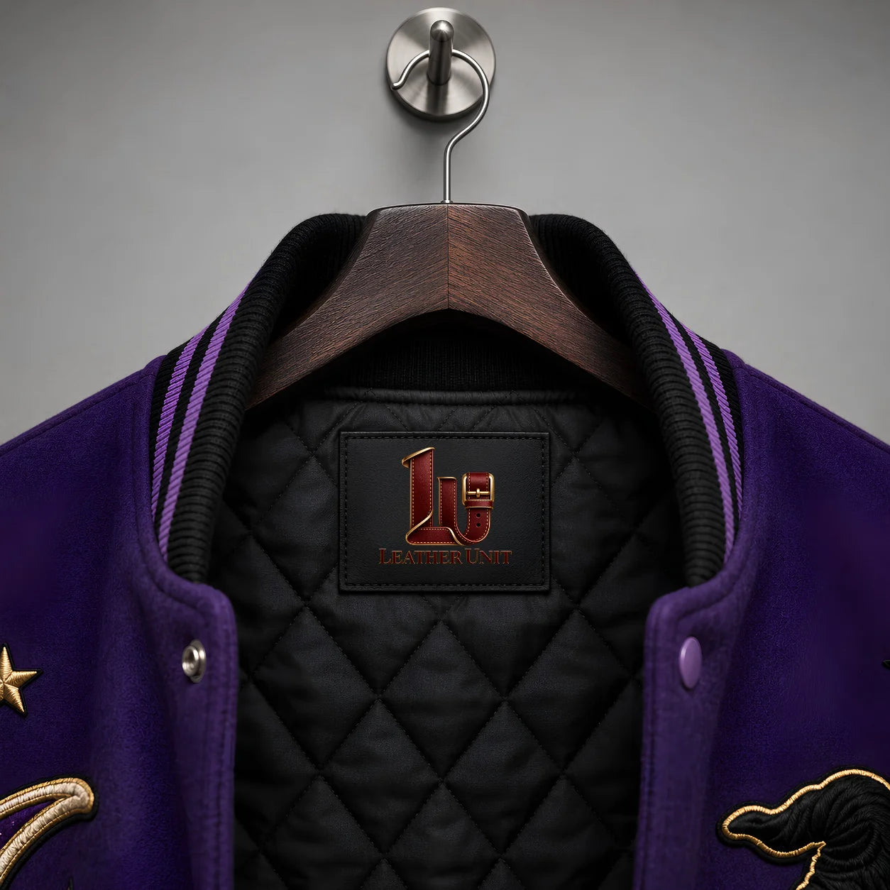 Close-up of Witching Hour varsity jacket collar, black quilted lining and Leather Unit interior branding label