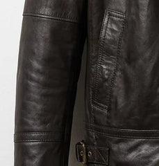 Waist pocket and leather texture close-up on women’s brown bomber jacket