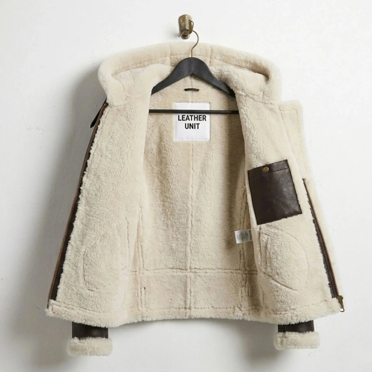 Inside view of women’s B3 aviator jacket showing full cream shearling lining and interior pocket