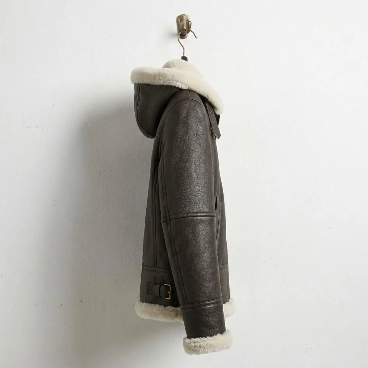 Side profile of women’s brown shearling hooded leather bomber jacket