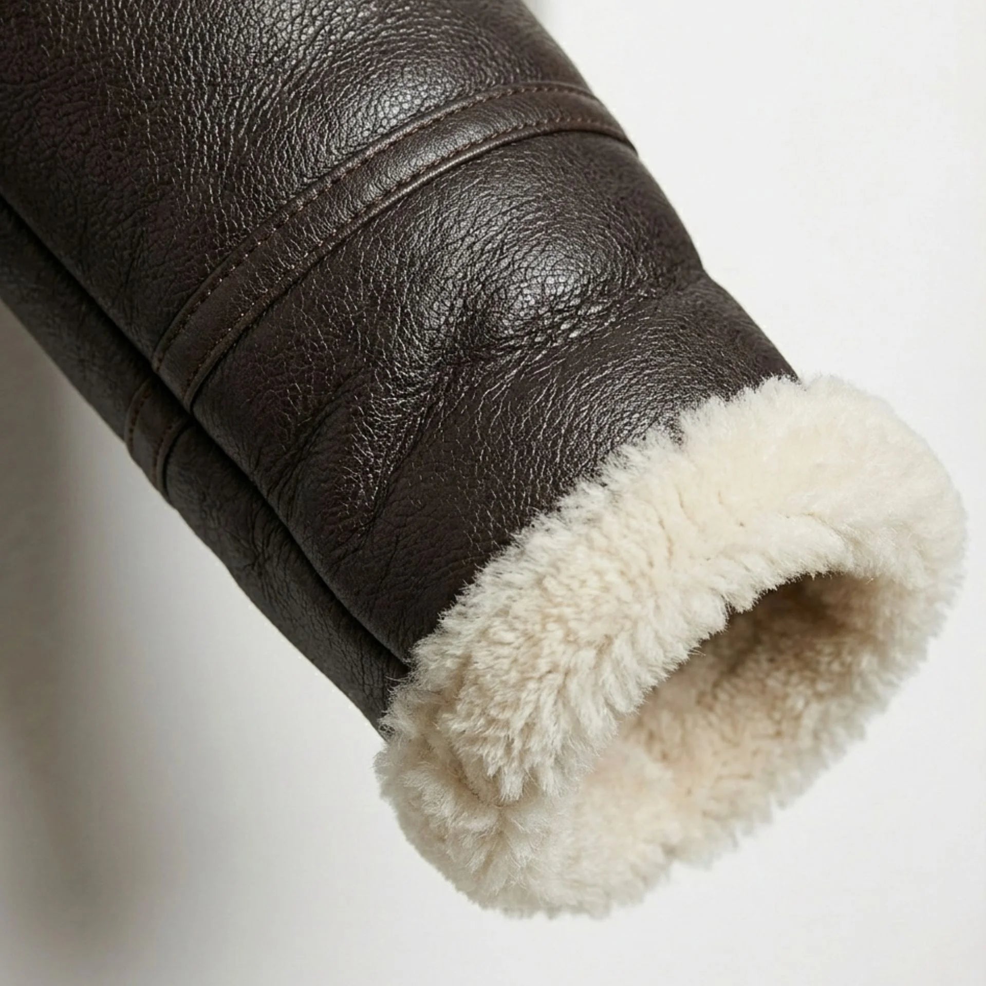 Close up of shearling cuff on women’s brown aviator leather jacket