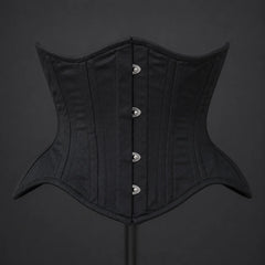 Front product view of black cotton underbust corset showing vertical boning channels and silver-tone busk fasteners