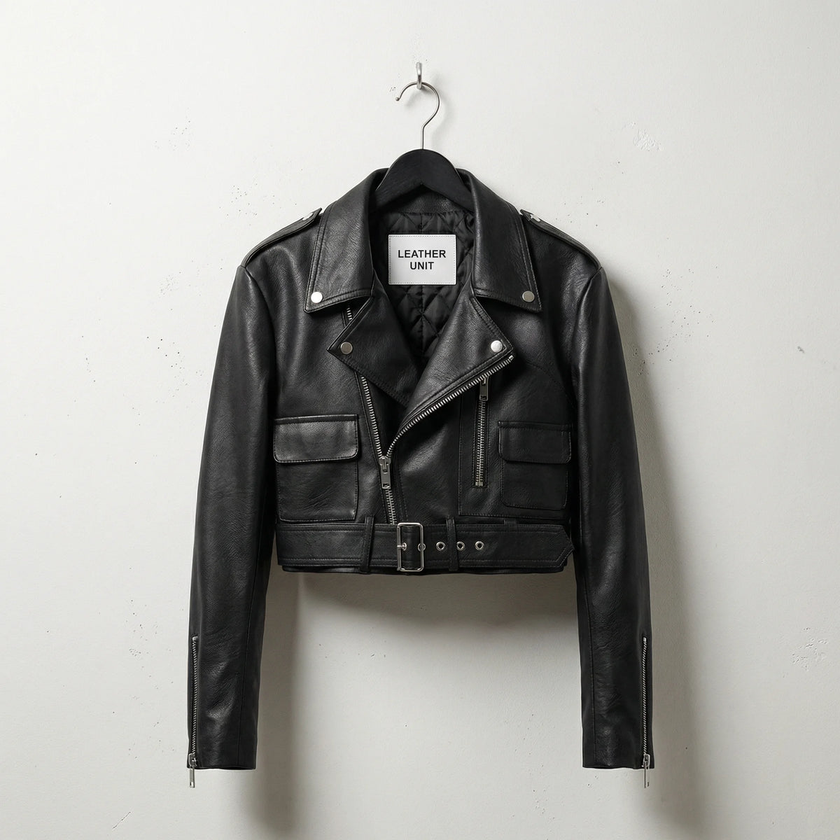 Front view of women’s black cropped leather biker jacket with belt by Leather Unit