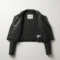 Inside view showing quilted lining of women’s black cropped leather biker jacket