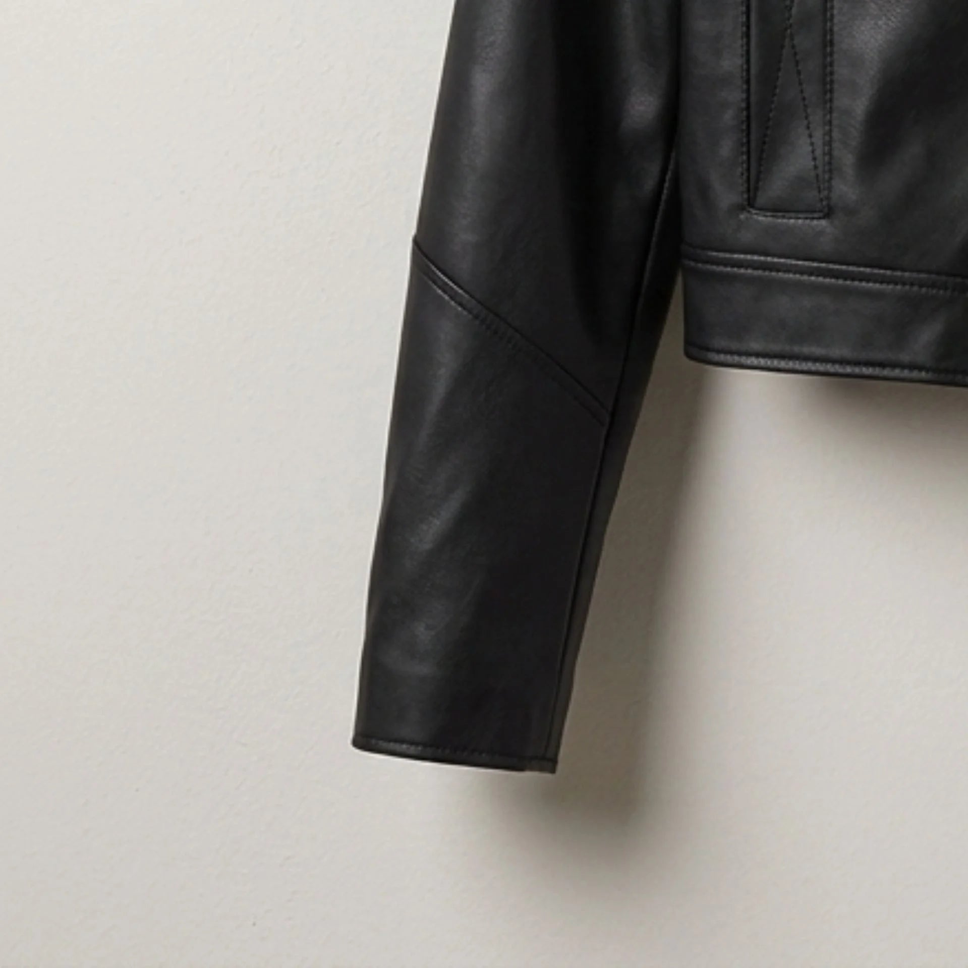 Sleeve and cuff detail on women’s black cropped leather jacket