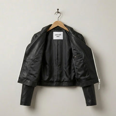 Inside view showing soft lining of women’s black cropped leather jacket