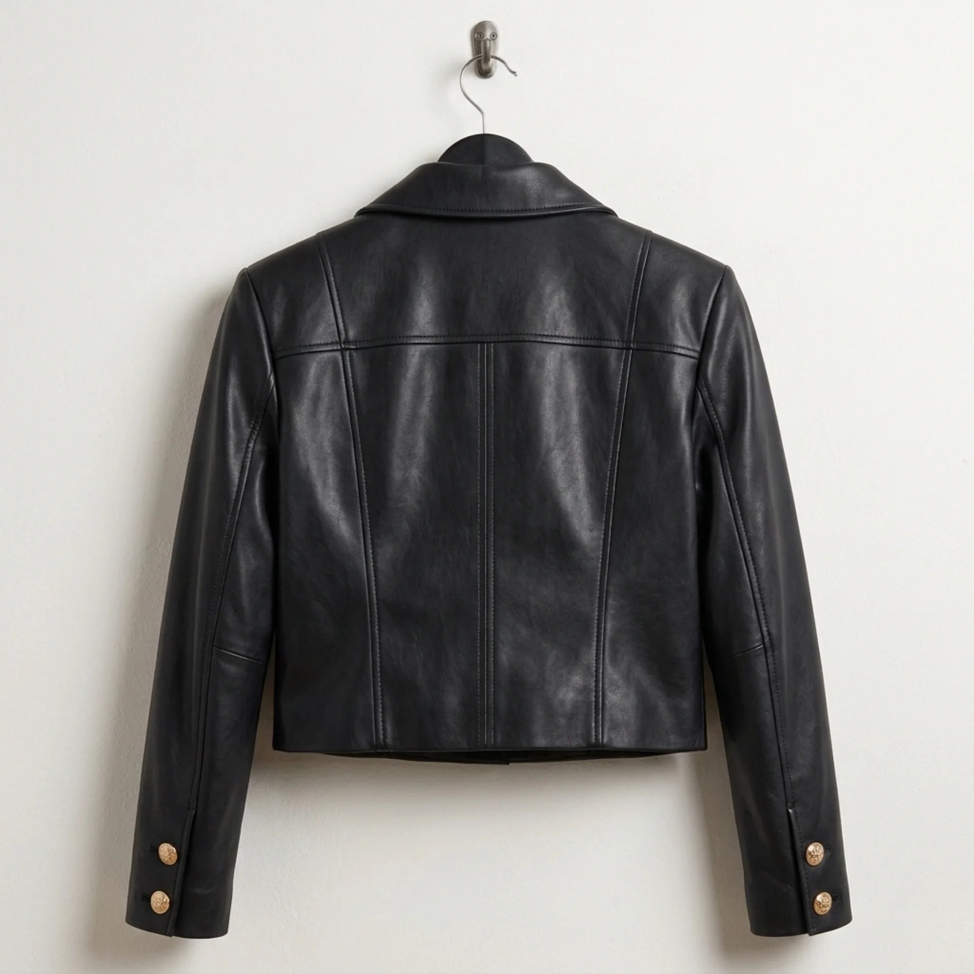 Back view of women’s cropped black leather military jacket
