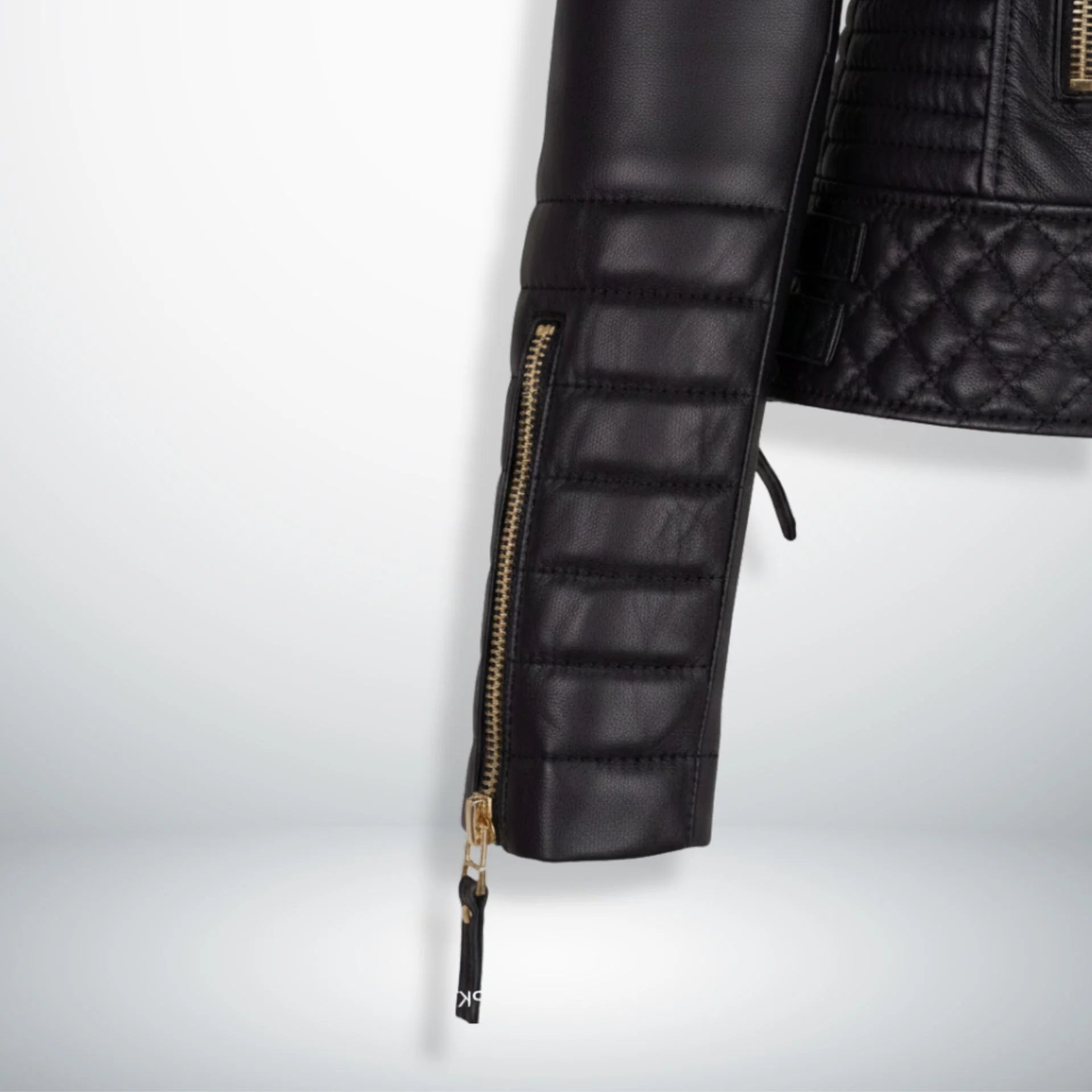 close up padded sleeve and zipper cuff on womens black motorcycle jacket.