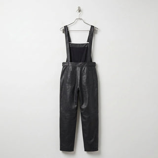 Back view of women’s black leather overalls showing rear pockets