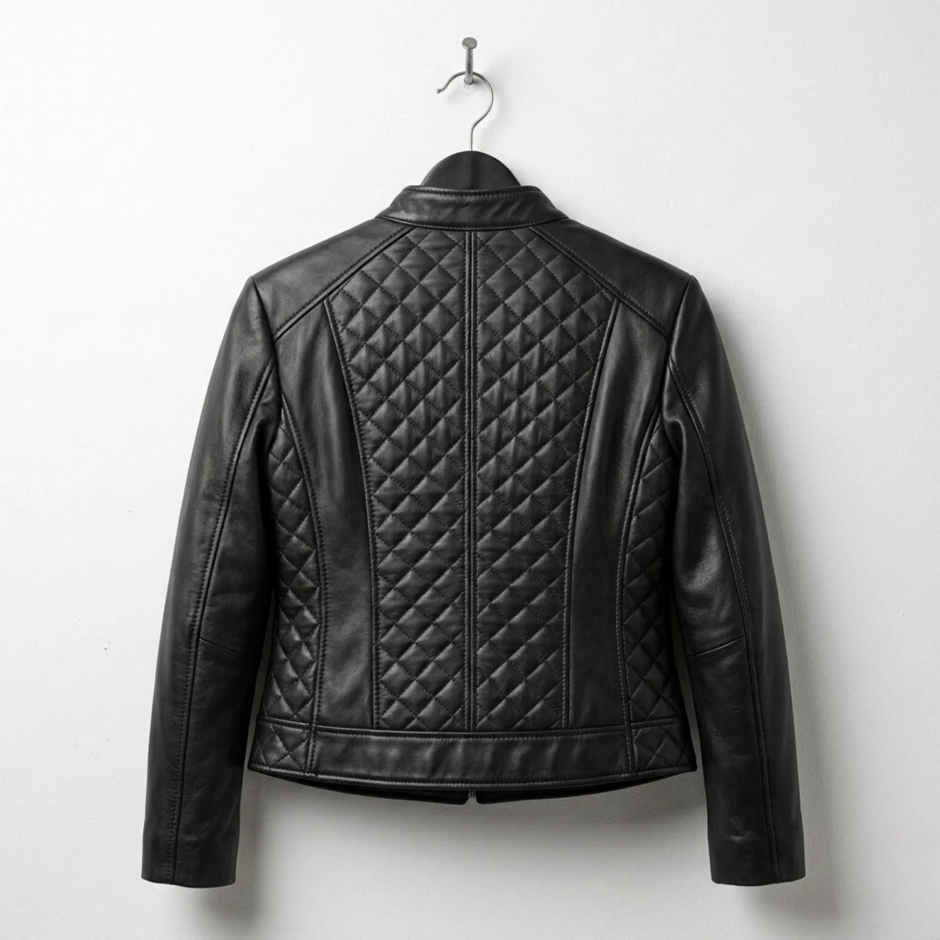 Back view of women’s black quilted leather moto jacket