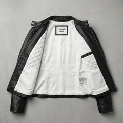 Inside view showing white lining of women’s black quilted leather jacket
