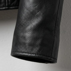 Sleeve and cuff close-up on women’s black leather jacket