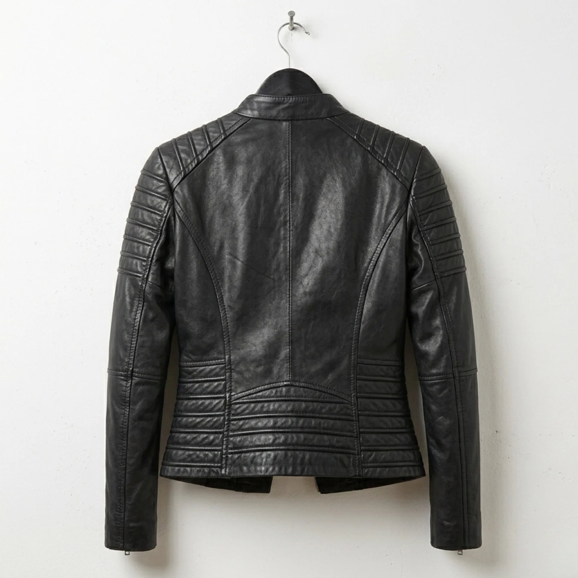 Back view of women’s black quilted leather motorcycle jacket