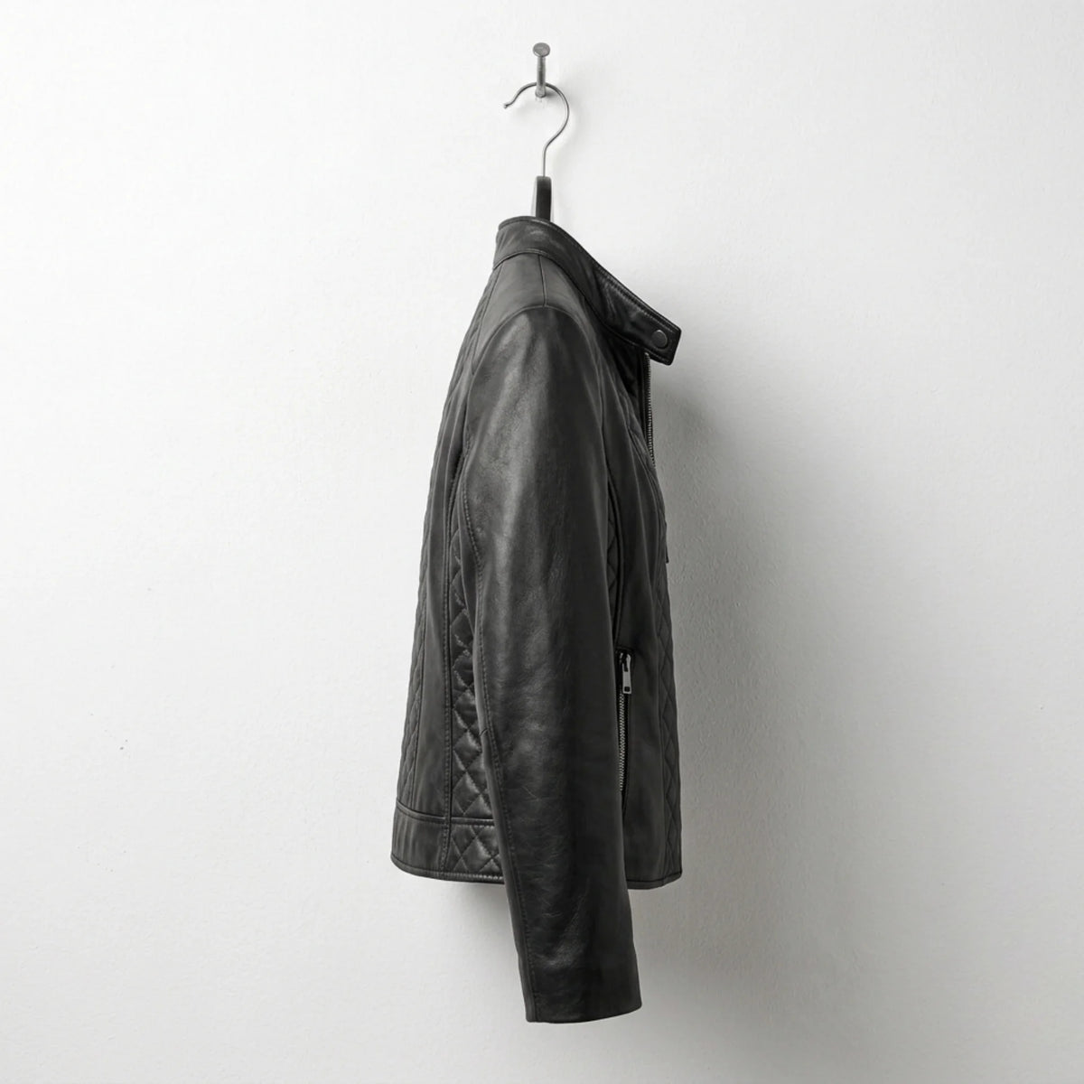 Side profile of women’s black quilted leather moto jacket