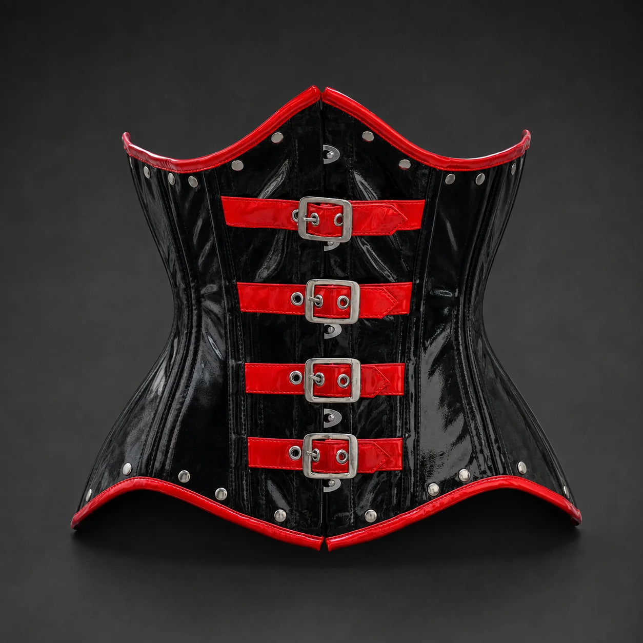 Front studio view of glossy black PVC underbust corset with four red buckle straps and silver-tone rivets
