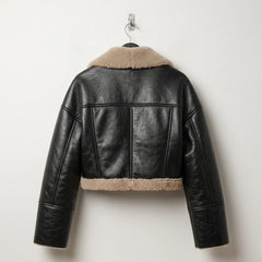 Back view of women’s black cropped shearling leather jacket